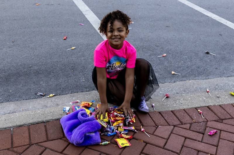 Ailani Fowler collects quite a bit of candy during the Joliet Central homecoming parade on Sept. 27. 2025.
