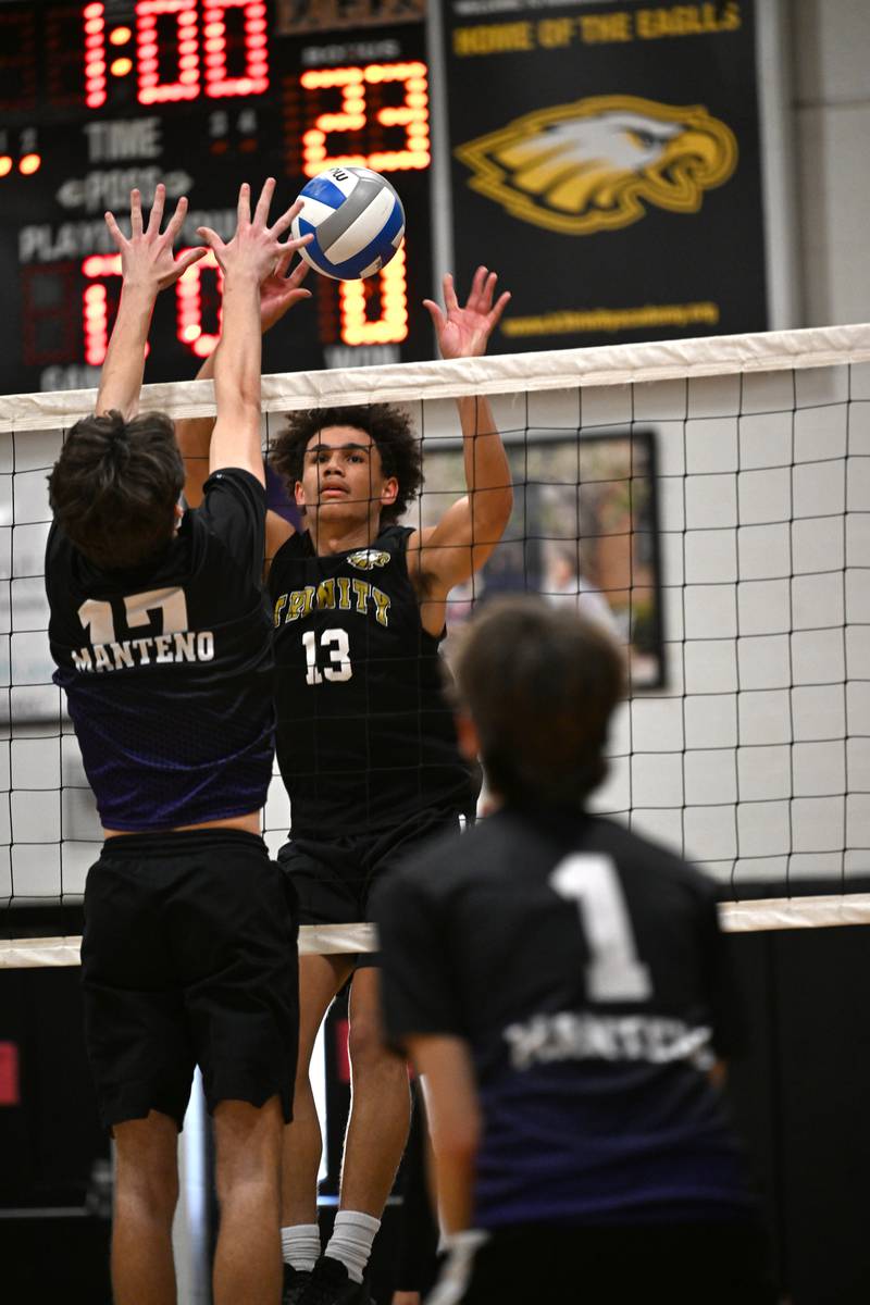 Kankakee Trinity Academy's Corey Hathaway sets the ball as Manteno's Cody Hall blocks the attempt during the game against Manteno on Thursday, May 1, 2025.
