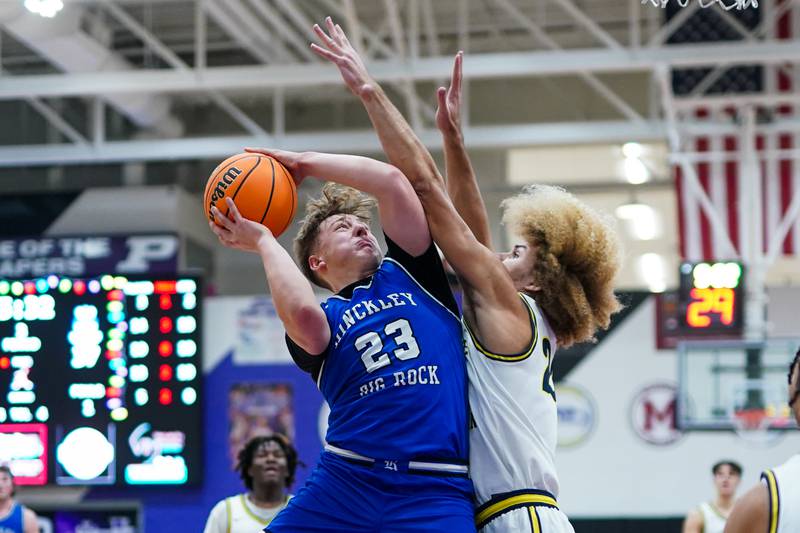 Hinckley-Big Rock's Luke Badal (23) shoots the ball in the post against Yorkville Christian's Noah Aguado (22) during a basketball game in the opening round of the 61st annual Plano Christmas Classic at Plano High School on Monday, December 23, 2024.