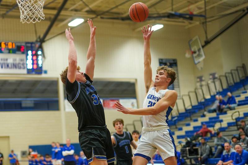 Geneva’s Jack Hatton (20) shoots a floater over St. Charles North's Jake Furtney (33) during a basketball game at Geneva High School on Wednesday, Feb 14, 2024.