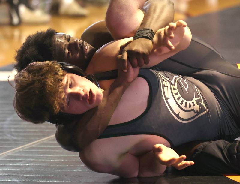 DeKalb’s Cam Matthews scores points against Sycamore’s Douglas Gemberling Friday, Jan. 17, 2025, during their 165 pound match at DeKalb High School.