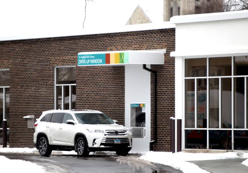 A patron uses the drive-up window at the St. Charles Public Library Monday, Jan, 24, 2022. The library has temporarily closed to in-person visits after staff allegedly received threats regarding the library's mask policy