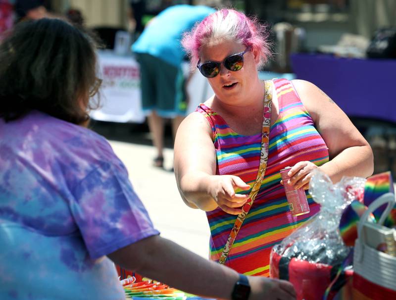 Kris Higgins, from Sycamore, checks out one of the vendors Saturday, June 21, 2025, during the DeKalb Pride Fest in front of the Egyptian Theatre in DeKalb.
