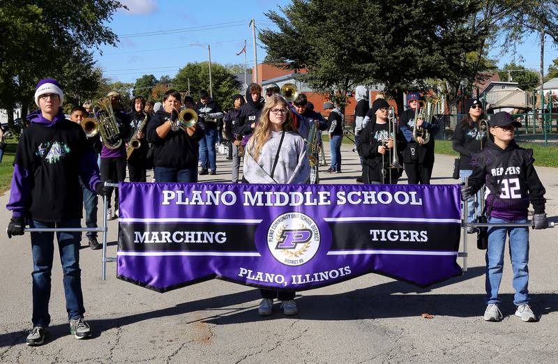 The Plano Middle School Marching Tigers line up before the Plano High School Homecoming Parade starts on Saturday, Oct. 7, 2023 in Plano.