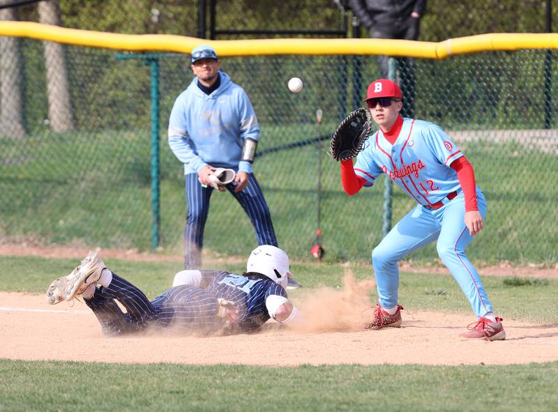 Benet's Liam Zickert (12) takes a pick-off attempt against Nazareth's Jaden Fauske (21) during the varsity baseball game between Benet Academy and Nazareth Academy in La Grange Park on Monday, April 24, 2023.