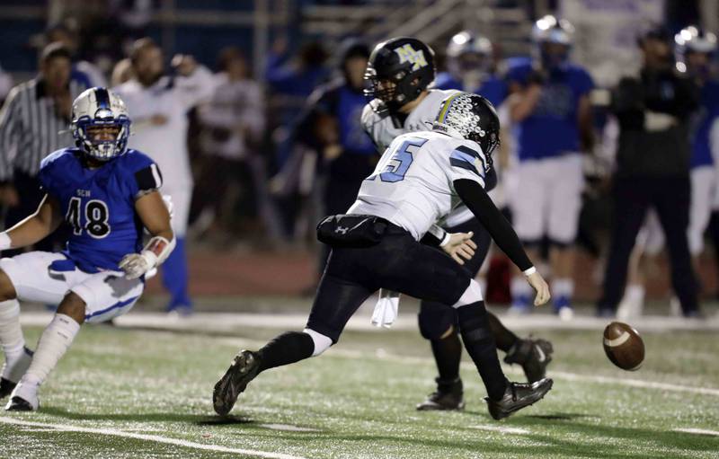 Maine West’s Thomas Delaney (15)  tries to pick up a loose ball Friday October 28, 2022 in St. Charles.