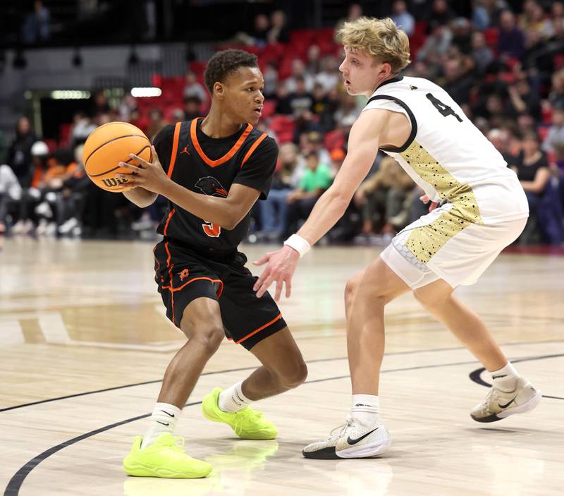 DeKalb's Bryan Miller works against Sycamore's Isaiah Feuerbach during their game Friday, Jan. 31, 2025, in the FNBO Challenge in the Convocation Center at Northern Illinois University in DeKalb.