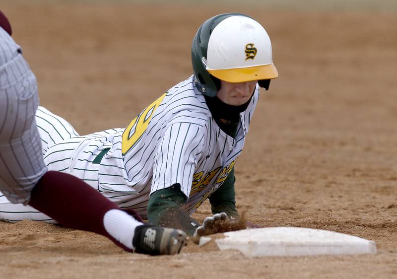 Crystal Lake South’s Joseph McEnery dives back to first base during a nonconference baseball game against Richmond-Burton Friday, March 24, 2023, at Crystal Lake South High School.