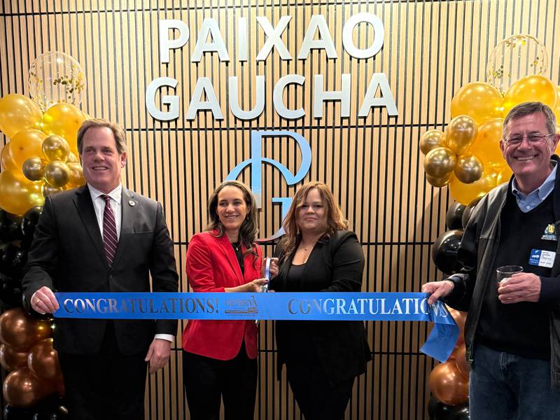 The Geneva Chamber of Commerce celebrating PaixPhotoao Gaucha Brazilian Steakhouse's grand opening.