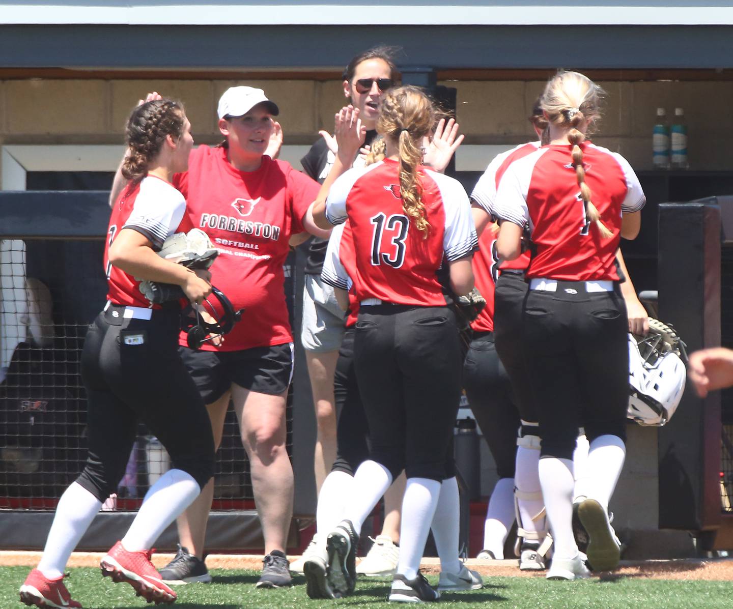 Forreston's head coach Kim Snider hi-fives players as they enter the dugout after running off the field between innings against Casey in the Class 1A State Softball semifinal game on Friday, June 3, 2022 at the Louisville Slugger Sports Complex in Peoria.