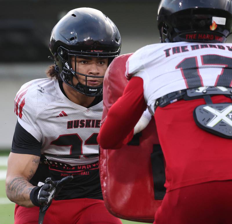 Northern Illinois University linebacker Deacon King (left) gets ready to take on a block Tuesday, April 14, 2026, during a drill at practice in Huskie Stadium at NIU in DeKalb.
