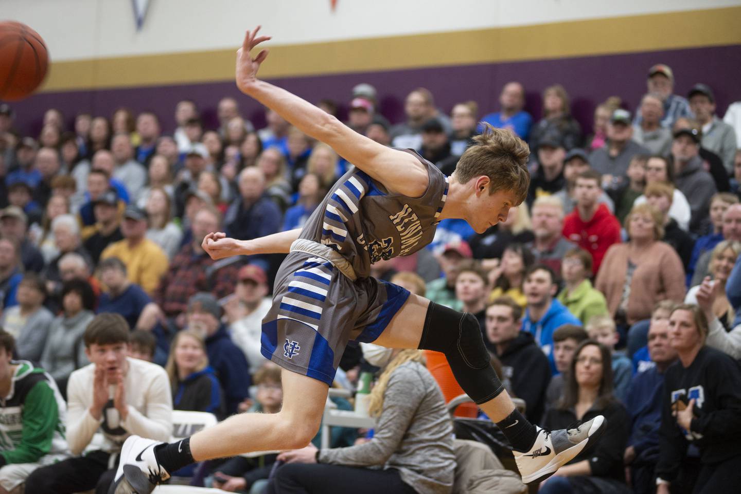 Newman's Lucas Simpson saves a ball from going out of bounds against Scales Mound in the sectional final Friday, March 4, 2022.