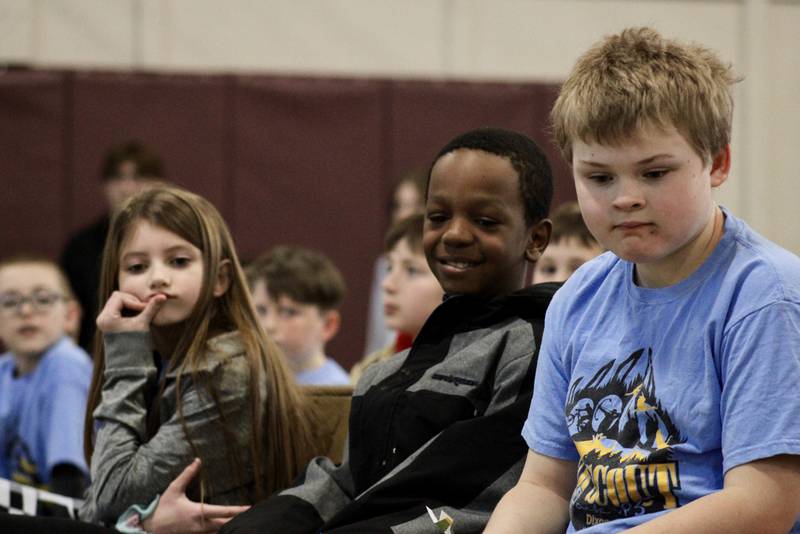 Webelos, from left, Claire Cofelt, Keyontez Lumzy and Jeremy Blaine watch their pinewood derby cars race toward the finish on Saturday, Feb. 11, 2023 during the Cub Scout Pack 85 Derby at Bethel Evangelical Congregational Church in Dixon.