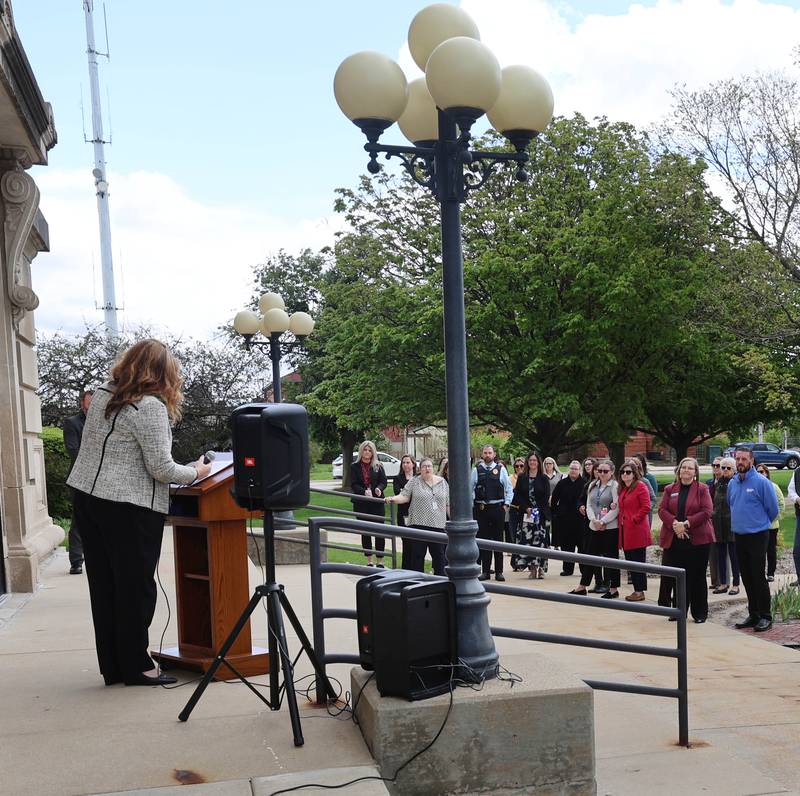 Associate Judge Sarah Gallagher-Chami speaks to onlookers Wednesday, April 29, 2026, during Hands Around the Courthouse at the DeKalb County Courthouse in Sycamore. The event was held to mark Child Abuse Prevention Month.