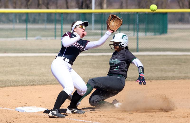 Marengo’s Ellie White snags the ball as North Boone’s Kieyra Robinson slides safely into third base in varsity softball at Marengo High School in Marengo on Saturday, March 22, 2025.