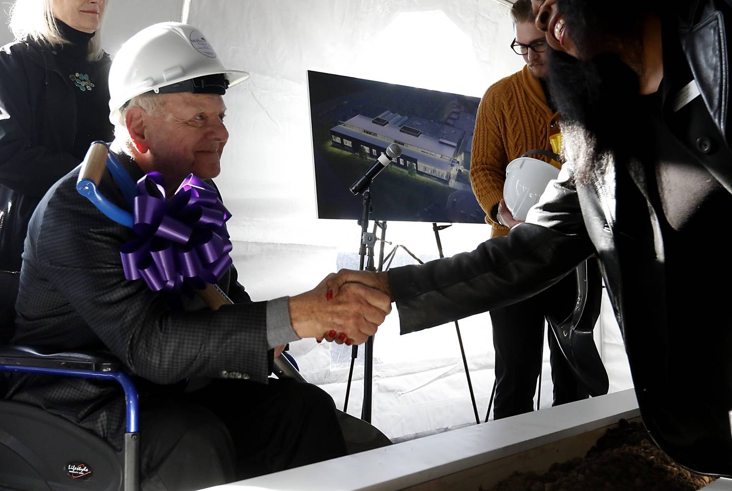 Former Sage Products Chairman and CEO and current Foglia Family Foundation Vice President Vince Foglia shakes hands Wednesday, Oct. 19, 2022, during a groundbreaking ceremony for McHenry County College’s Foglia Center for Advanced Technology and Innovation at the Crystal Lake campus.  During the ceremony, speakers spoke about the future of learning in the new center along with education's role in economic development.
