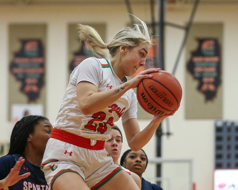 Plainfield East's Lexi Sepulveda (23) grabs a rebound during basketball game between Romeoville at Plainfield East. Feb 8, 2024.