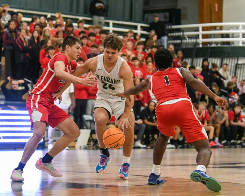 Glenbard West's Brady Johnson (24) gets doubled teamed by Glenbard East teammatesJacob Marynowski, left, and Keenan House (1) on Wednesday Nov. 26, 2025, during the District 87 Thanksgiving Invitational held at Glenbard West High School.