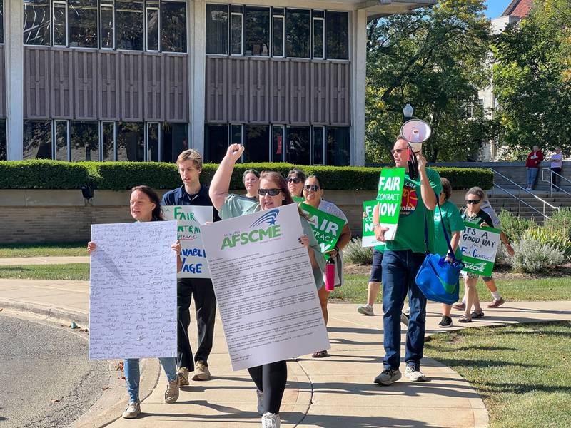 The president of AFSCME 1890, Rave Meyer leads a group of union supporters through Northern Illinois University on Sept. 16, 2025. They were on their way to invite university president Lisa Freeman to their next public contract negotiation.