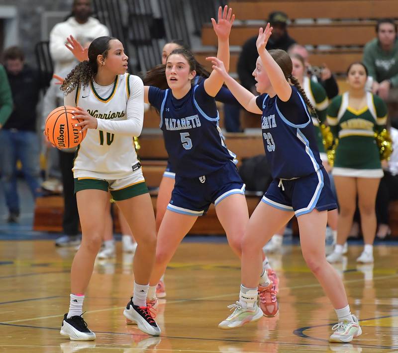 Waubonsie Valley’s Danyella Mporokoso (10) is double teamed by Nazareth’s Sophia Towne (5) and Molly Moore during the Class 4A Lyons Supersectional game on March 2, 2026 at Lyons Township High School in LaGrange.