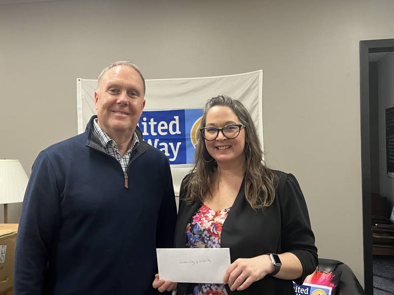 Steve Vanisko, publisher for The Herald-News in Joliet (left), presents a check for $15,017.17 to Sarah Oprzedek, president and CEO of United Way of Will County (right). The donation was the result of a yet another record-breaking Herald Angels campaign, which was held during the holidays of 2023.