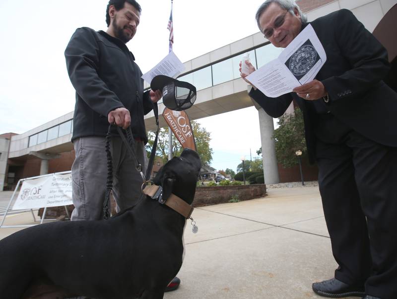Everardo Espinoza of La Salle, has his dog Jojo blessed by Father Nick Husain during the OSF Healthcare Blessing of the Animals on Friday, Oct. 4, 2024 at OSF Saint Elizabeth Medical Center in Peru. The blessing is a celebration of St. Francis of Assisi, who was known for his live of animals.