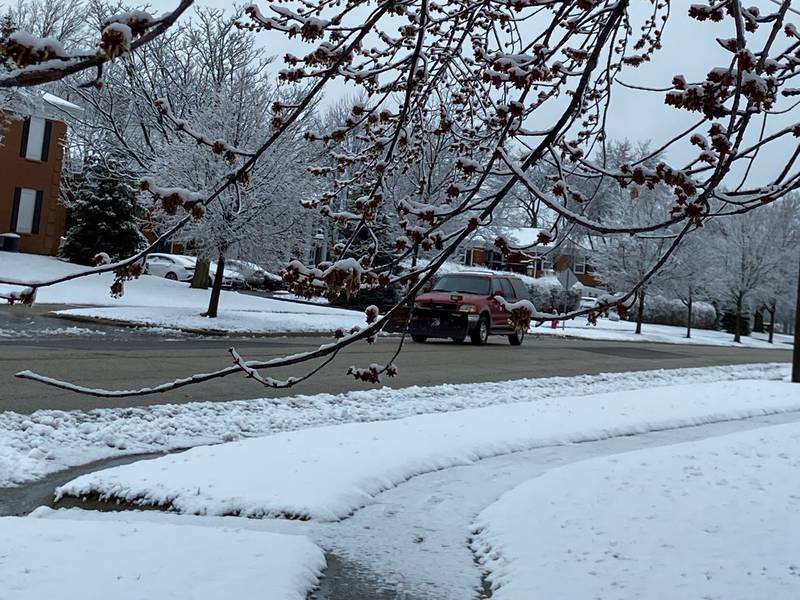 A sports utility vehicle moves down Devonshire Lane on Saturday, March 25, 2023, in Crystal Lake after snow fell overnight into Saturday and into the morning.