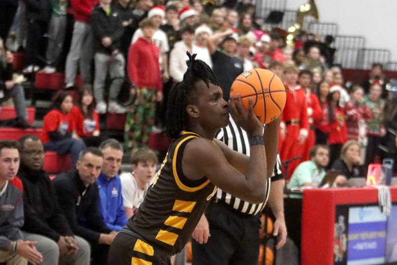 Jacobs’ Malachi Bell launches a three-point shot in varsity boys basketball on Friday, Dec. 12, 2025, at Dundee-Crown High School in Carpentersville.