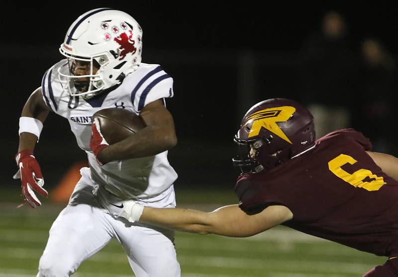 St. Viator's Dayvion Ellis tries to get away from the tackle of Richmond-Burton's Ryan Wisniewski during a IHSA Class 4A first round playoff football game Friday, Oct. 27, 2023, at Richmond-Burton High School in Richmond.