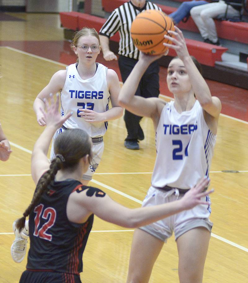 Princeton’s Keighley Davis eyes the basket over the block attempt of Metamora’s Addy Wooden in the 2nd period Tuesday at the Ottawa Holiday Tournament.
