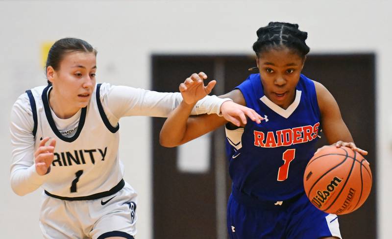 Glenbard South’s Rheayanna Ferguson, right, fends off Trinity’s Luz Del Rosario Kwiatkowski during the Class 3A Glenbard South girls basketball sectional semifinal on Tuesday, Feb. 20, 2024 in Glen Ellyn.