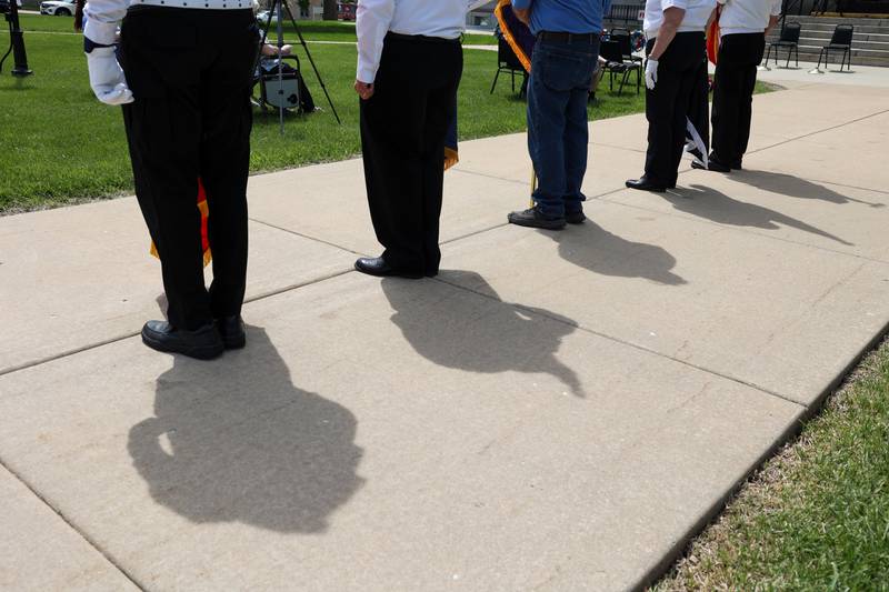 Members of Kankakee Veterans Council color guard cast shadows on the sidewalk on Monday, May 26, 2025, during the Kankakee County Veterans' Council annual Memorial Day Ceremony at the Kankakee County Courthouse.
