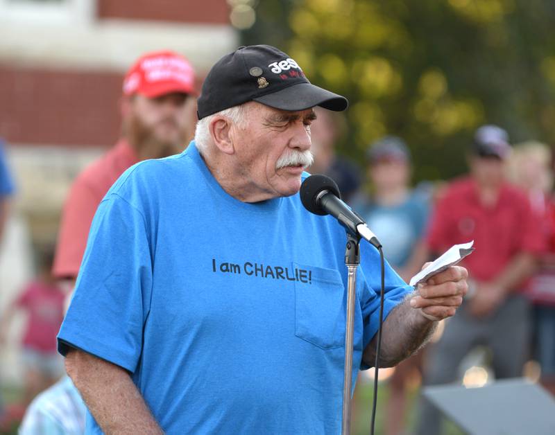 John Tuttle of Oregon, leads a prayer at the candlelight vigil for Charlie Kirk in front of the historic Ogle County Courthouse in downtown Oregon on Sunday, Sept. 14, 2025.