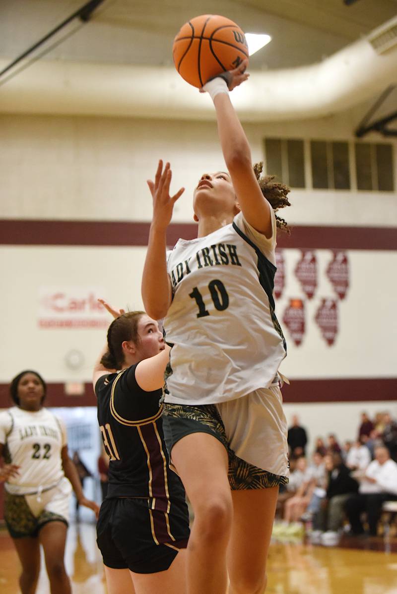 Bishop McNamara's Trinitee Thompson lays it up during the IHSA Class 2A Tolono Unity Super-Sectional against Mt. Carmel Monday, March 3, 2025.
