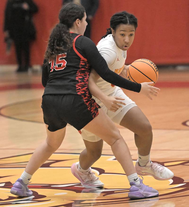 Batavia’s Sapphira Thompson-Woods tries to get past Maine South’s Hayden Fahy in a girls basketball game in Batavia on Tuesday, Jan. 14, 2025.
