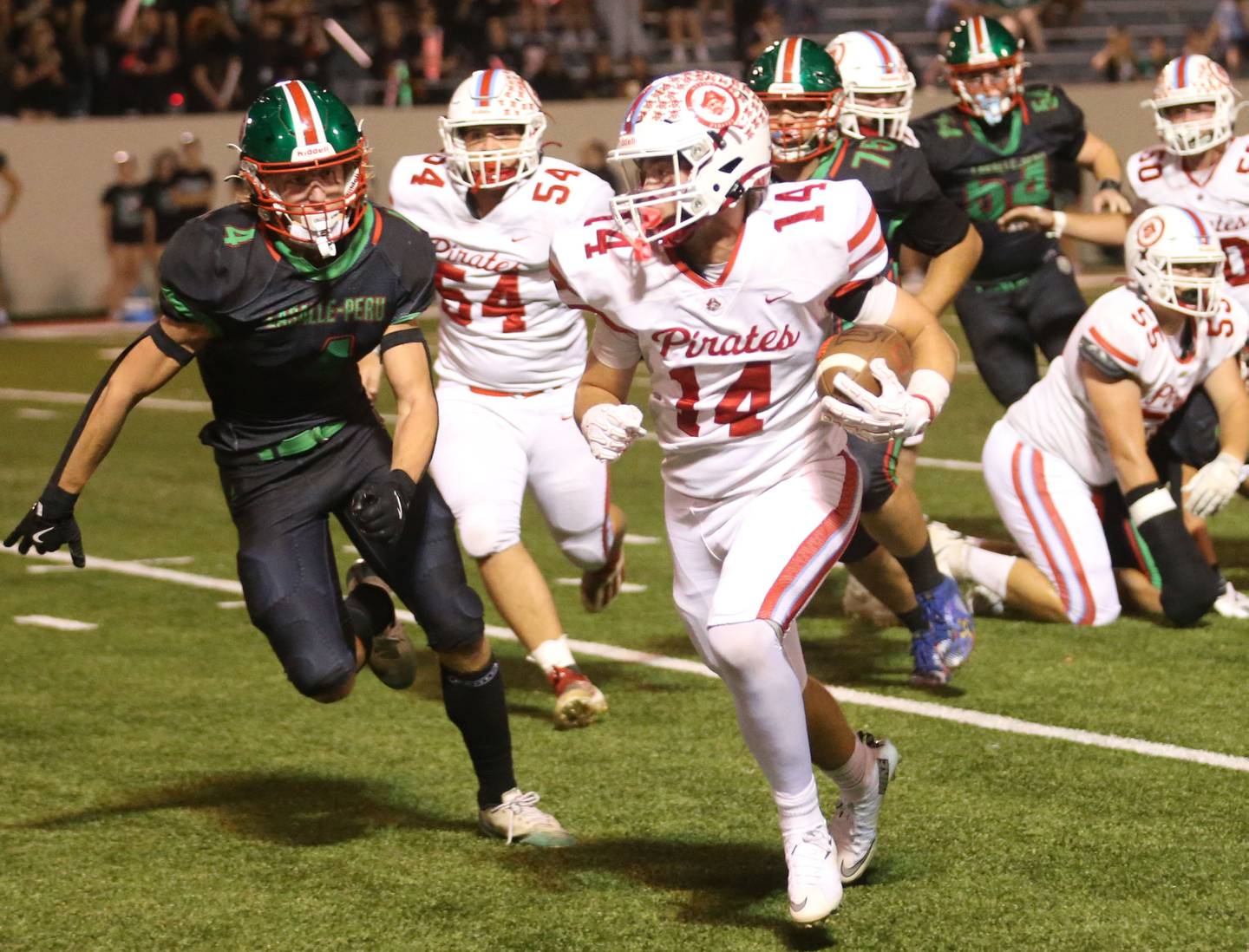 Ottawa's Archer Cechowiz runs with the ball as L-P's Mason Morscheiser chases after him on Friday, Oct. 3, 2025 at Howard Fellows Stadium.