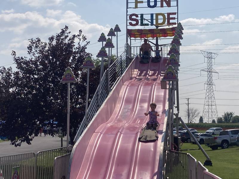 Guests at the Shorewood Crossroads Festival carnival ride the "fun slide" attraction on Saturday, August 2, 2025.