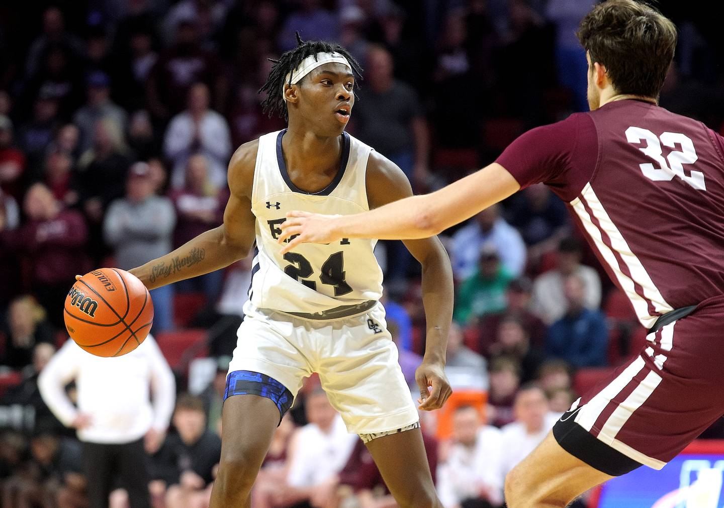 Oswego East's Mekhi Lowery looks for an open teammate in the second half of his team's supersectional game against Moline. The Wolves fell 59-55 to the Maroons ending this season Class 4A postseason run.    (Photo: PhotoNews Media/Clark Brooks)