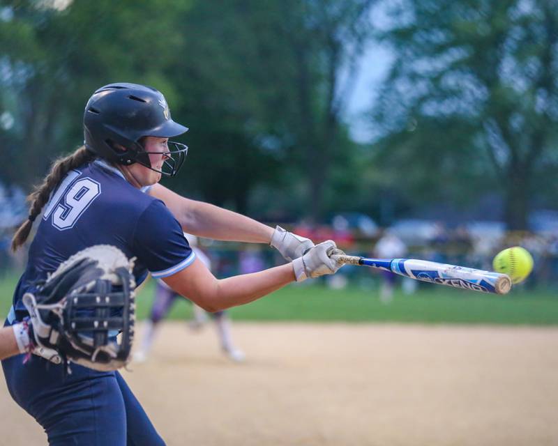 Downers Grove South's Ella Cushing (19) connects on a pitich during varsity softball game between Downers Grove South at Downers Grove North.  May 11, 2023.