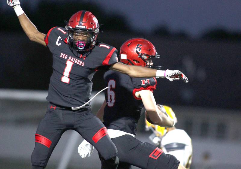 Huntley’s Jacob Witt, back, celebrates with Bryce Walker (1) after a Witt touchdown against Jacobs in varsity football in Huntley Friday night.