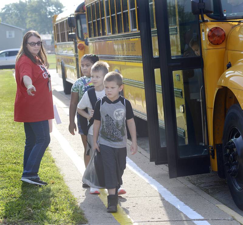 Centennial School staff direct students after they leave the bus on the first day of school Wednesday in Streator.