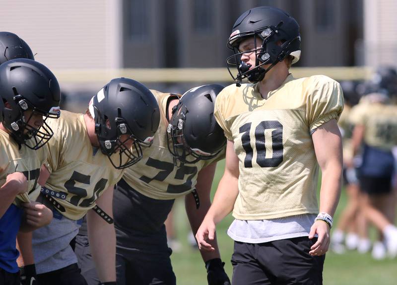 Sycamore quarterback Burke Gautcher calls a play in the huddle during practice Monday, July 17, 2023 at the school.
