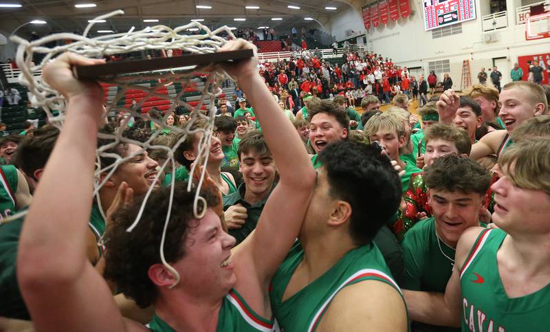 L-P's Mikey Hartman (left) hoists the Class 3A Regional title plaque after defeating Streator on Friday, Feb. 28, 2025 in Sellett Gymnasium at L-P High School.