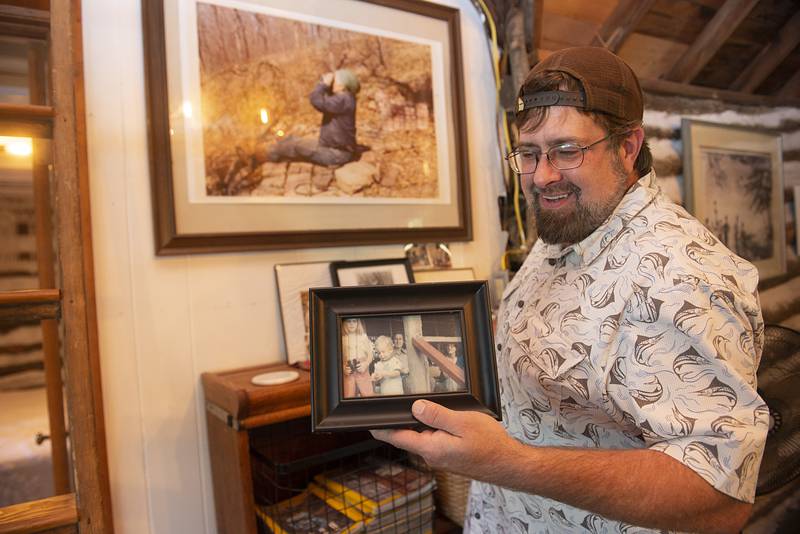 Tim Benedict keeps a photo of his sister and himself displayed on the porch of the cabin.