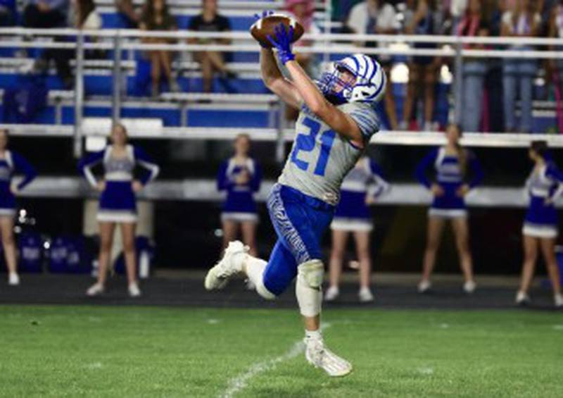 Princeton's Abram Longeville hauls in a pass against Kewanee defender Friday at Bryant Field. The Tigers won 63-12.