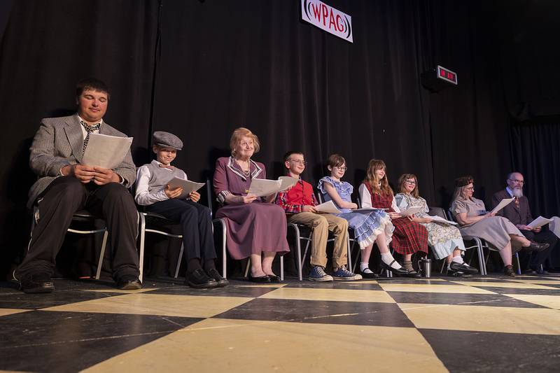 Actors line up for the next scene in The Performing Arts Guild’s rendition of “An Evening Around the Radio” during rehearsal Tuesday, April 18, 2023.