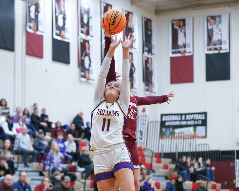 Downers Grove North's Abby Gross (11) leaps for a rebound during their Regional Final basketball game between Downers Grove North at Plainfield North. Feb 20, 2025 in Plainfield.