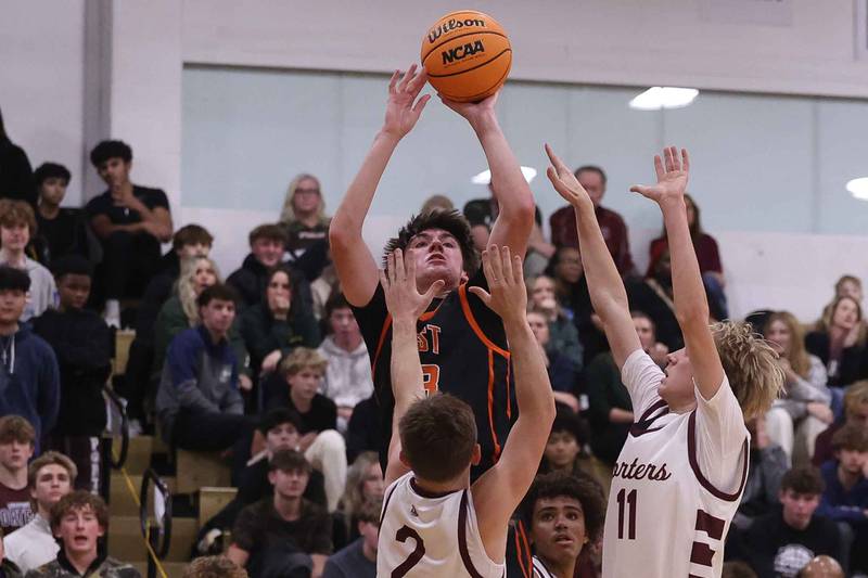Lincoln-Way West’s Wyatt Carlson shoots over the Lockport defenders on Friday, Dec. 6, 2024 in Lockport.