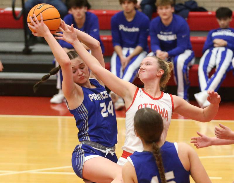 Princeton's Keighley Davis grabs a rebound over Ottawa's Skylar Dorsey on Monday, Feb. 3, 2025 in Kingman Gymnasium at Ottawa High School.