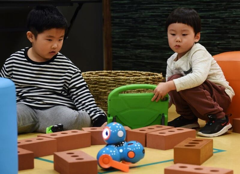 Aiden Lim, 4, of Glenview, left, and Aiden Rhee, 3, of Morton Grove work together to operate a robot at the Kohl Children's Museum in Glenview Tuesday.( Joe Lewnard | Staff Photographer)